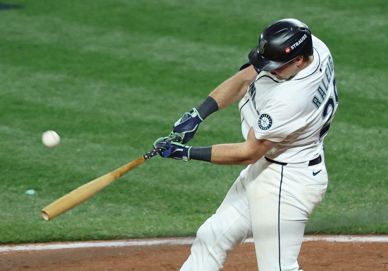 Cal Raleigh making contact while batting left-handed for Seattle